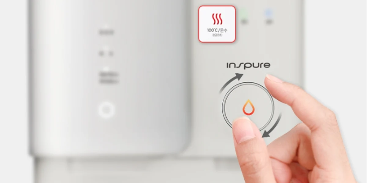 A hand operating the control dial of a Cuckoo Inspire water purifier with 100°C hot water setting. (cp-sn102hw)